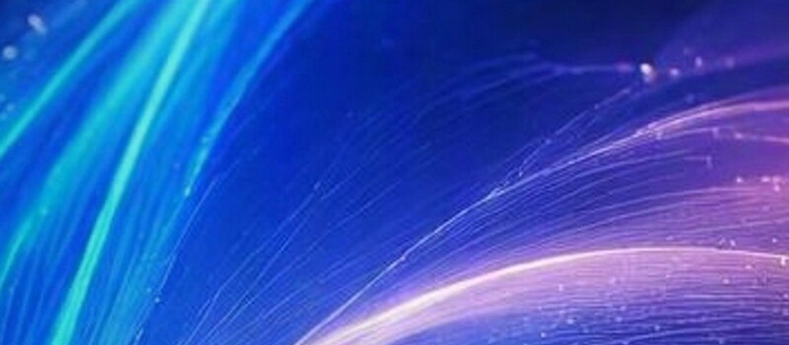 Flowing filaments of blue, ice blue and lavender light among softly glowing particles